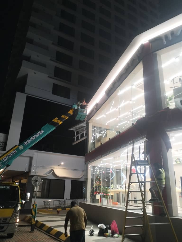 Night-time high-rise façade glass cleaning by boom lift